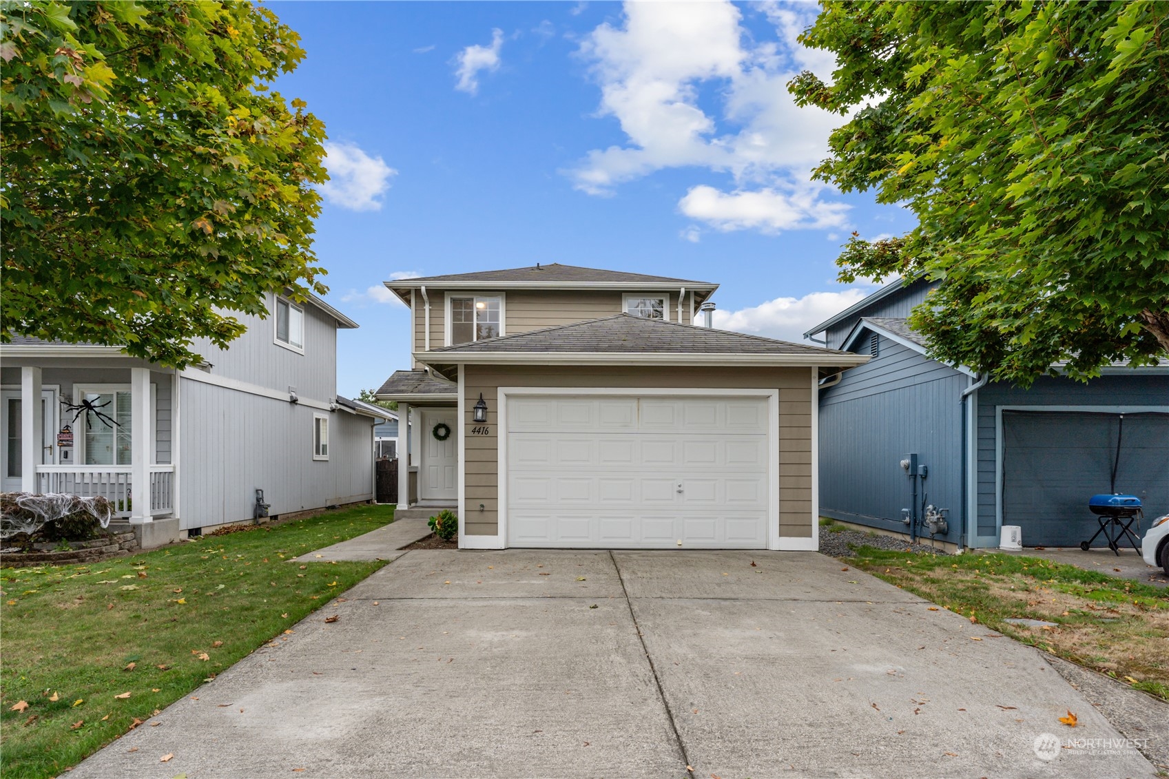 a front view of a house with a yard and garage