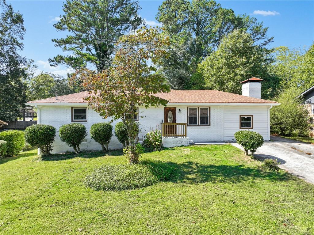 a front view of house with yard and green space