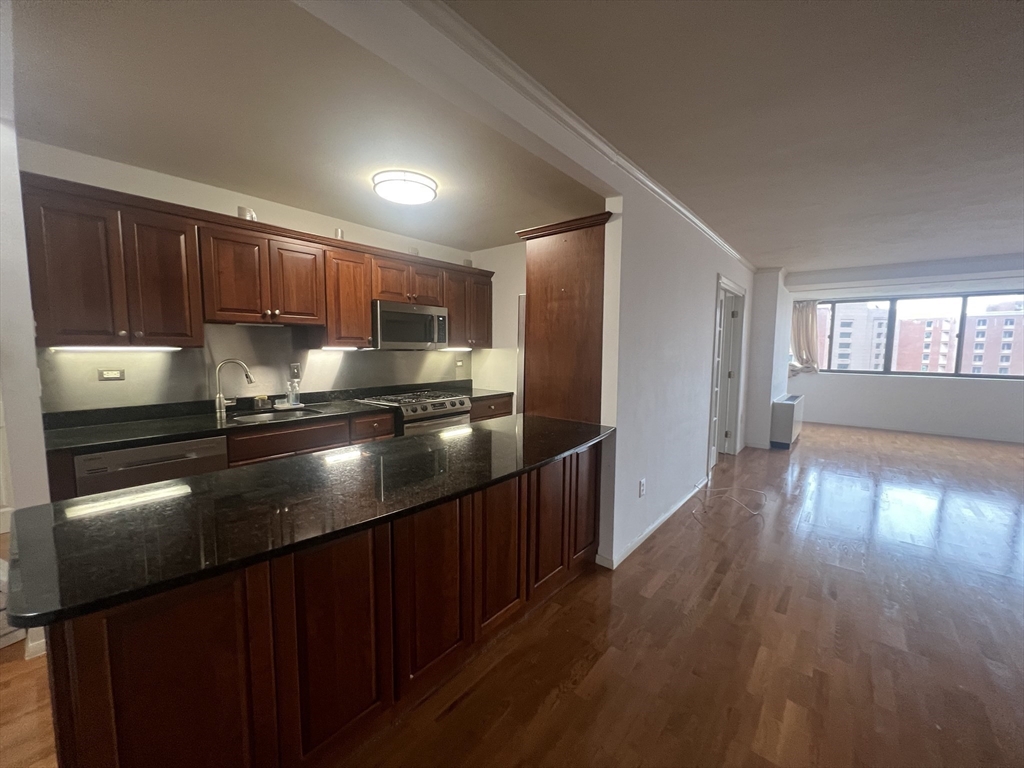 a kitchen with a refrigerator and a stove top oven