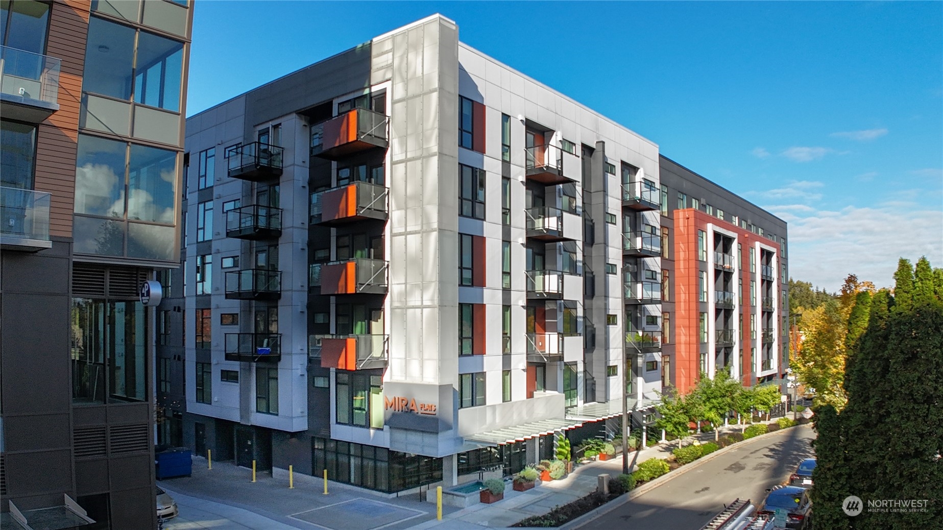 a front view of multi story residential apartment building with yard