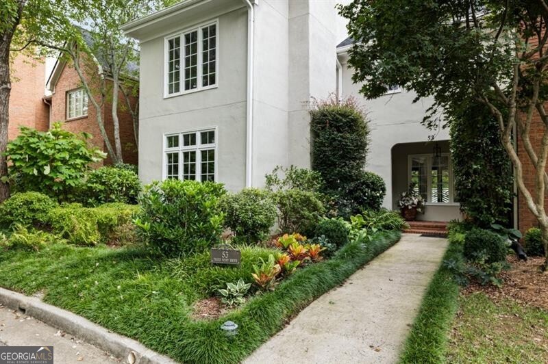 a front view of a house with garden