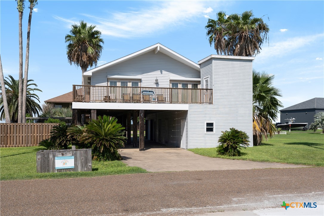 a front view of house with a garden