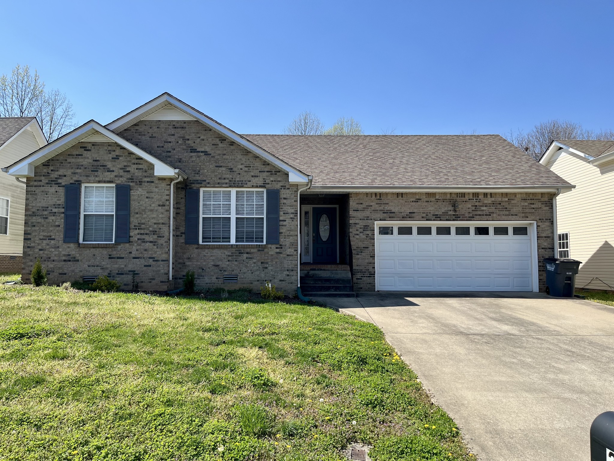 a front view of a house with yard and garage