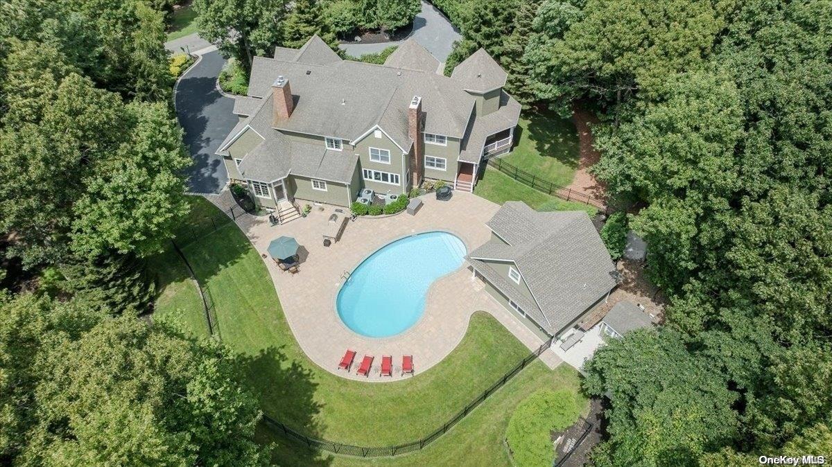 an aerial view of a house with a swimming pool and outdoor space