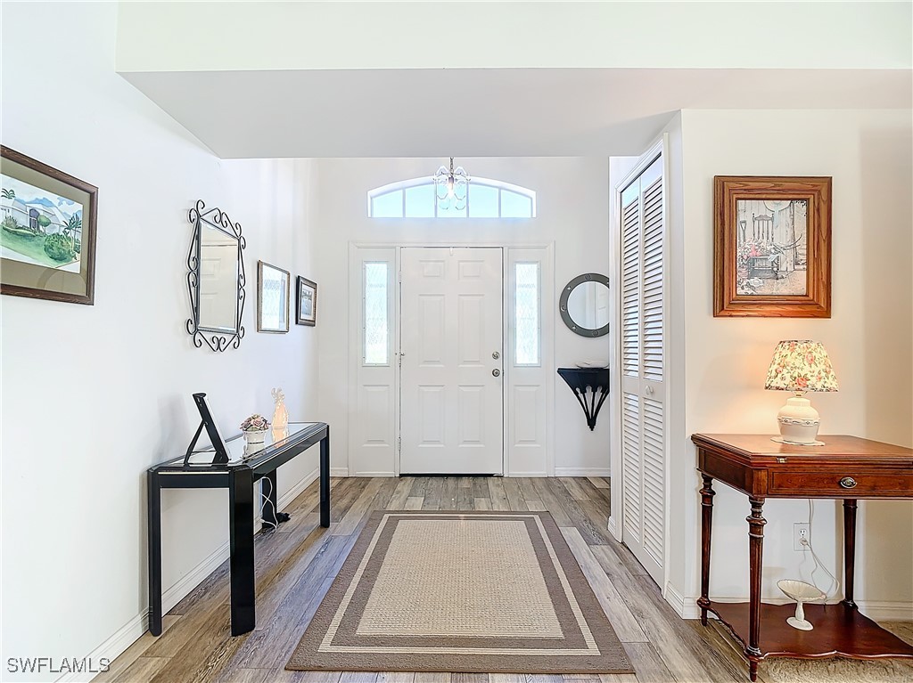 a living room with furniture a window and a chandelier