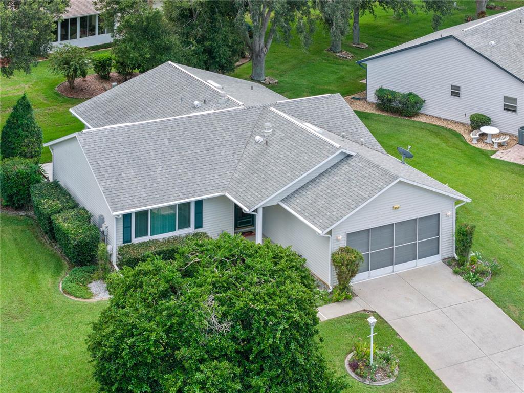 an aerial view of a house with a yard and garage