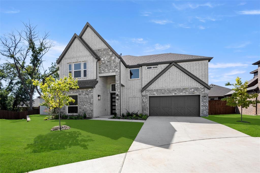 a front view of a house with a yard and garage