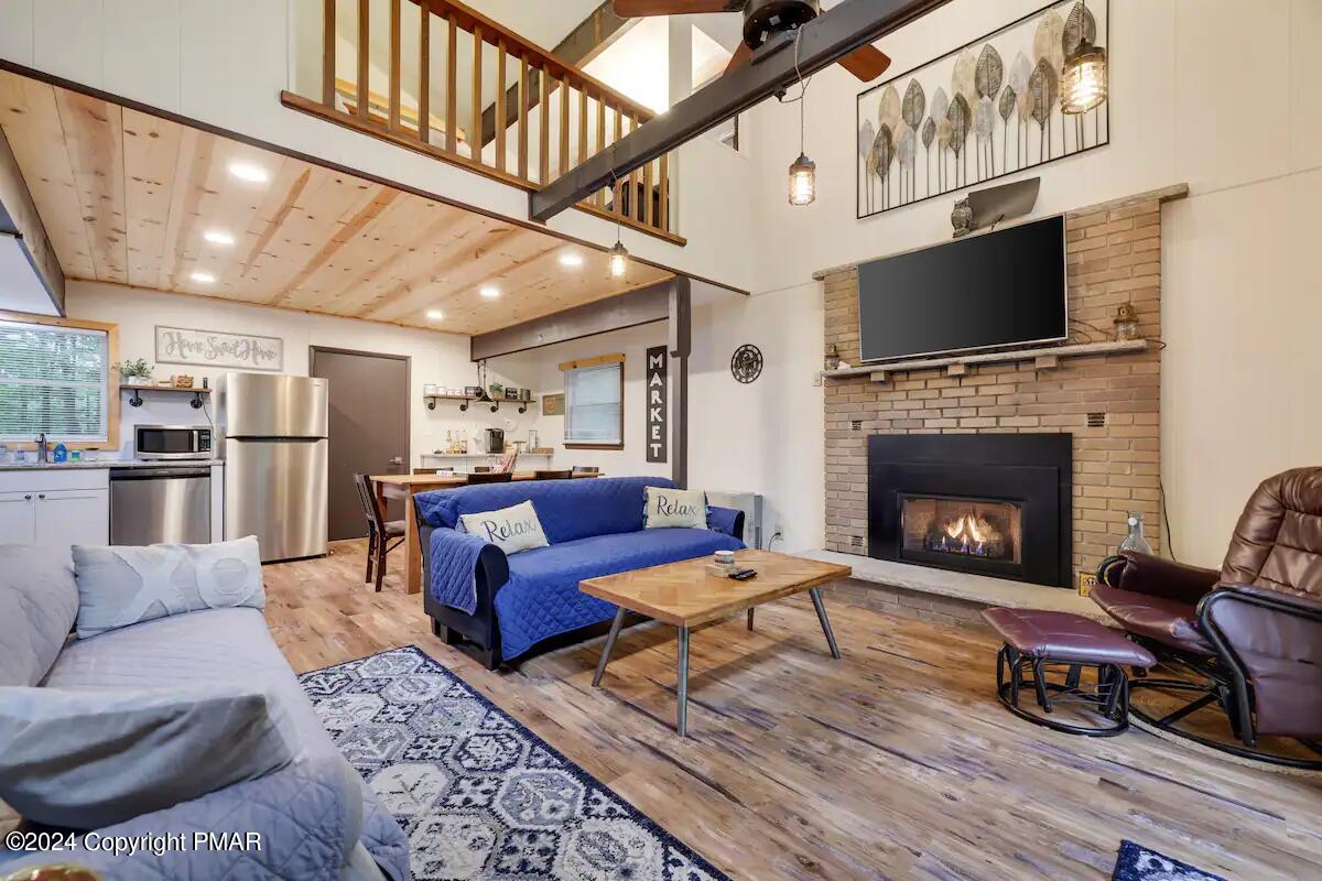 a living room with furniture a flat screen tv and a fireplace