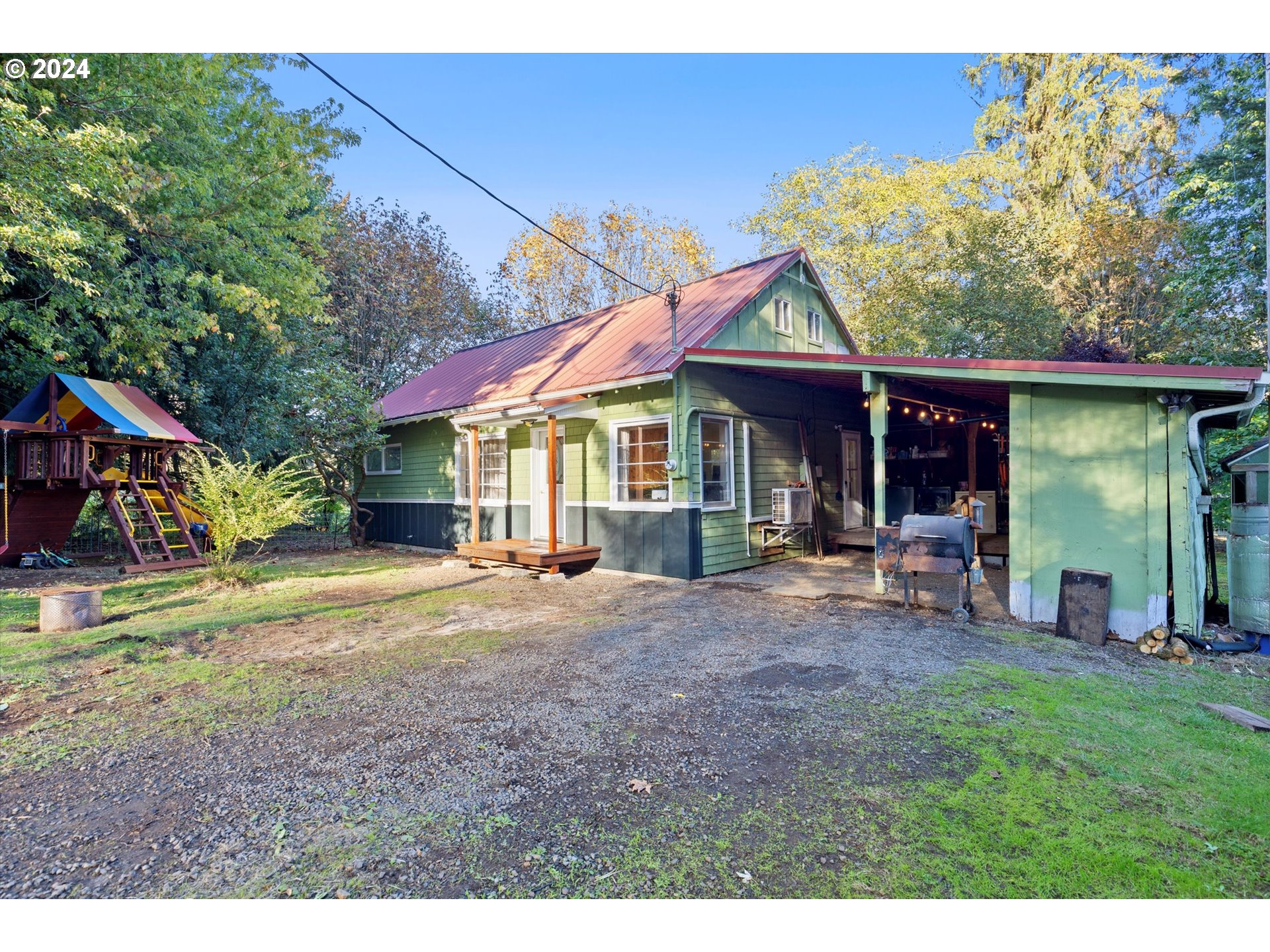 a view of a house with a yard patio and fire pit