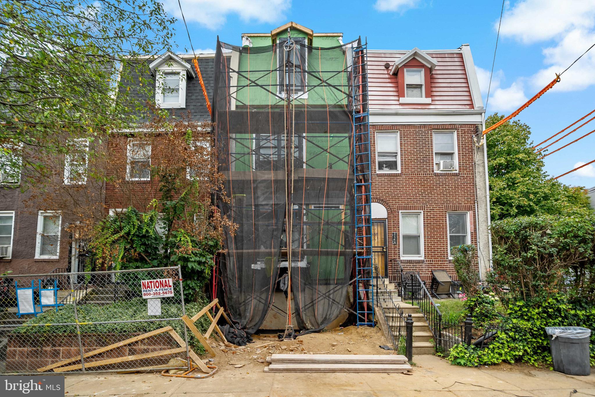 a view of a brick building next to a yard