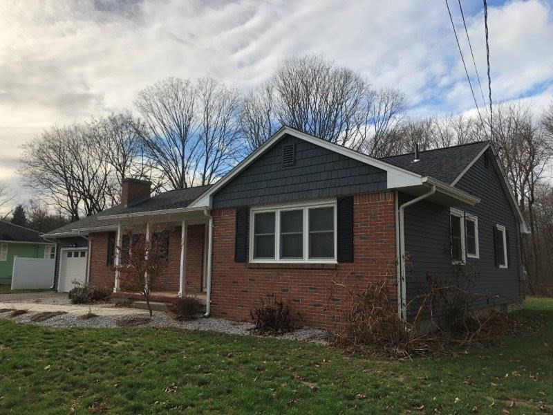 a front view of a house with a yard and porch