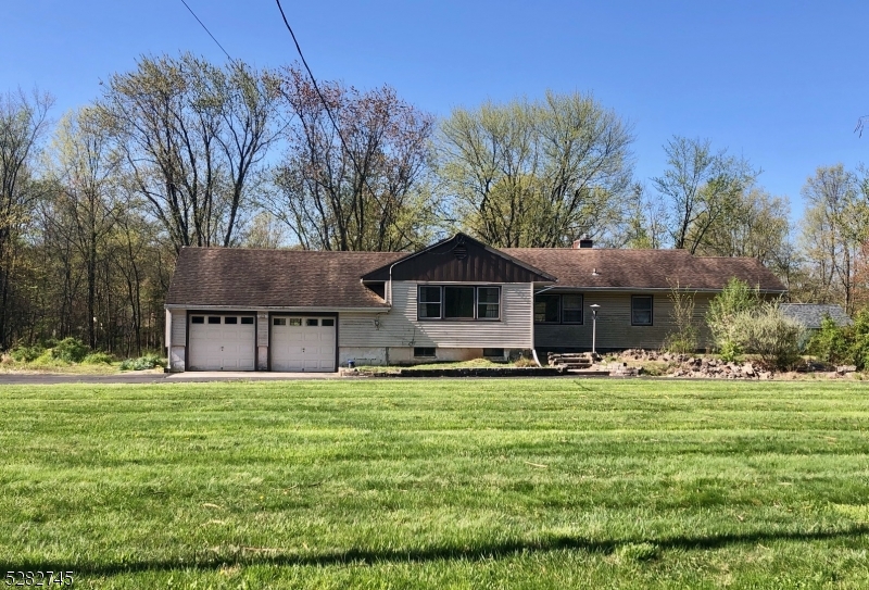 a house view with a sitting space and garden