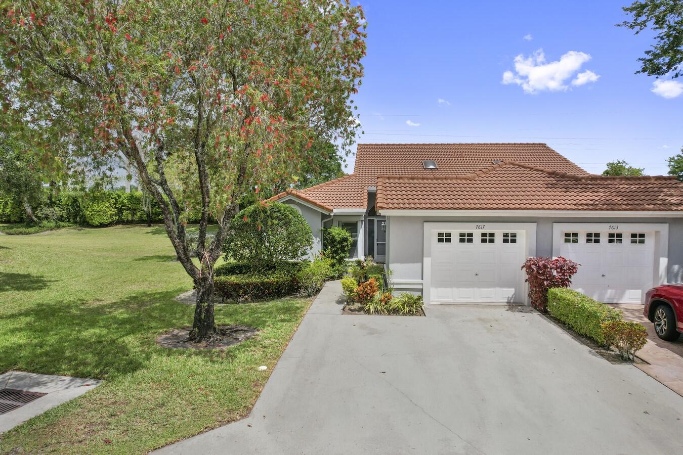 a front view of house with a garden