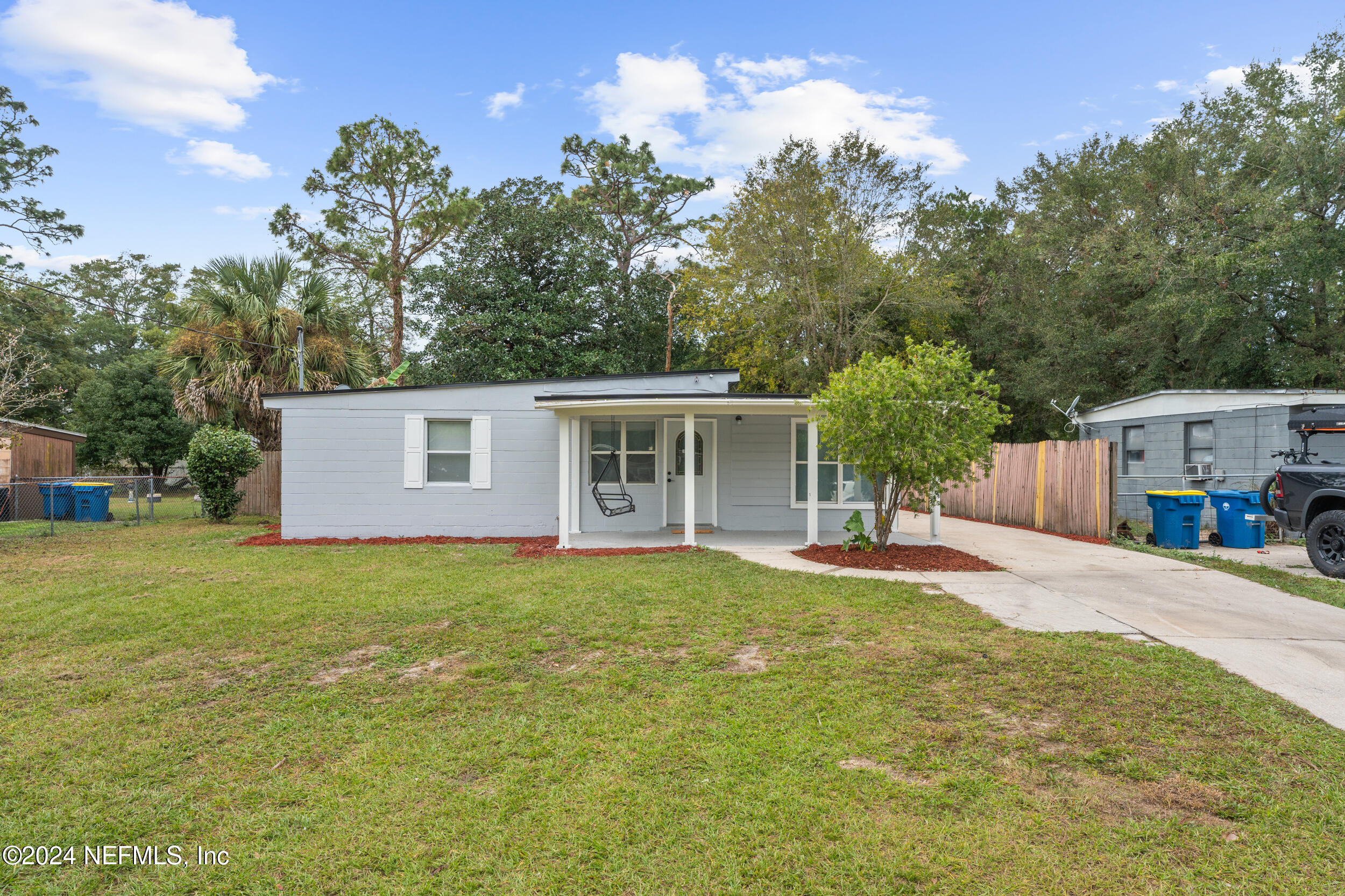 a front view of house with yard and trees