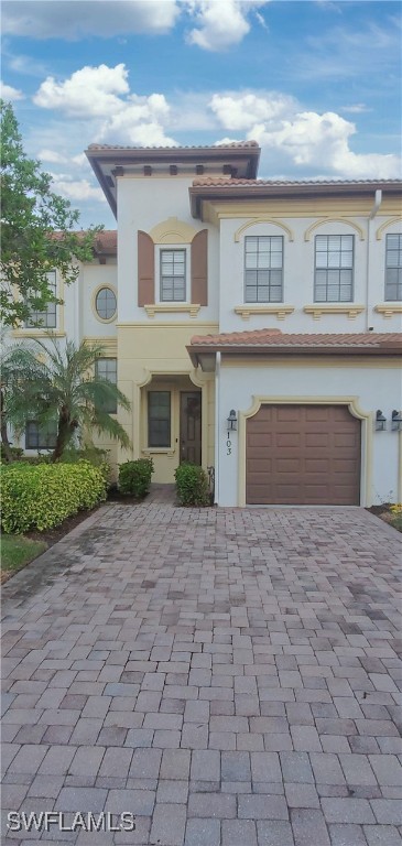 a front view of a house with yard and glass windows