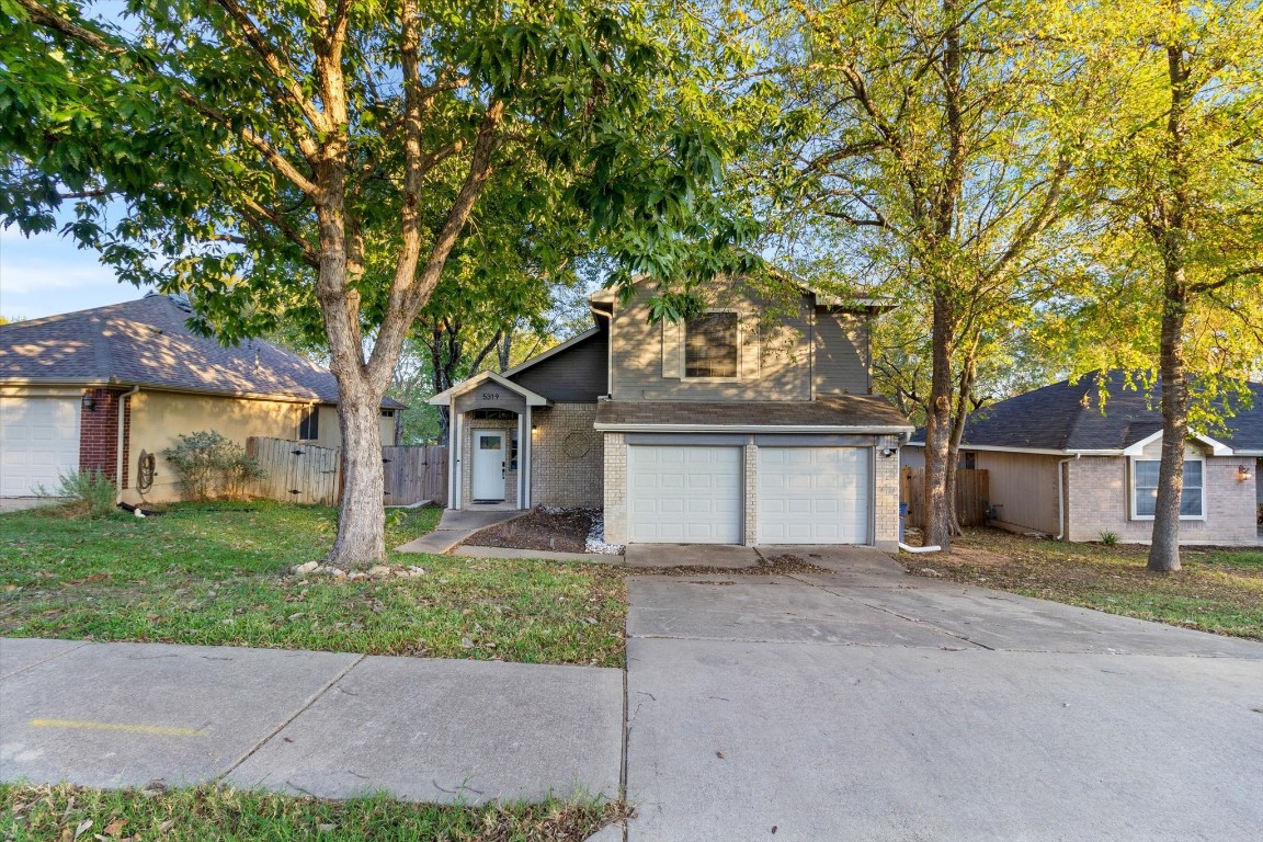 front view of a house with a trees