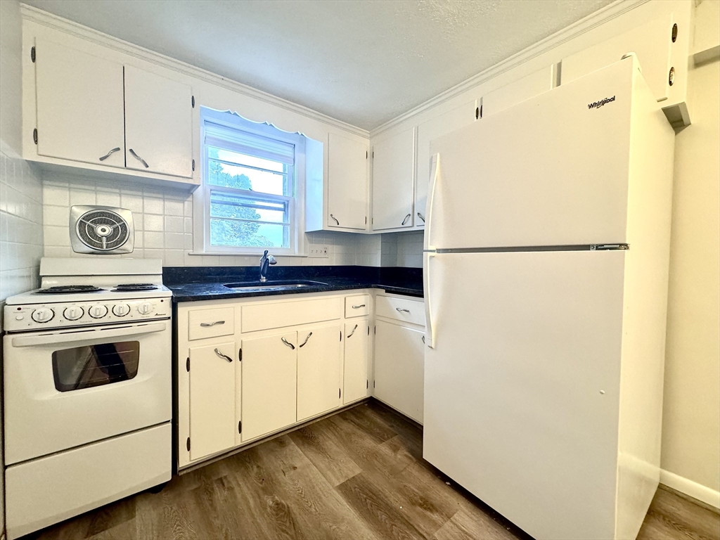 a kitchen with a white cabinets and white appliances