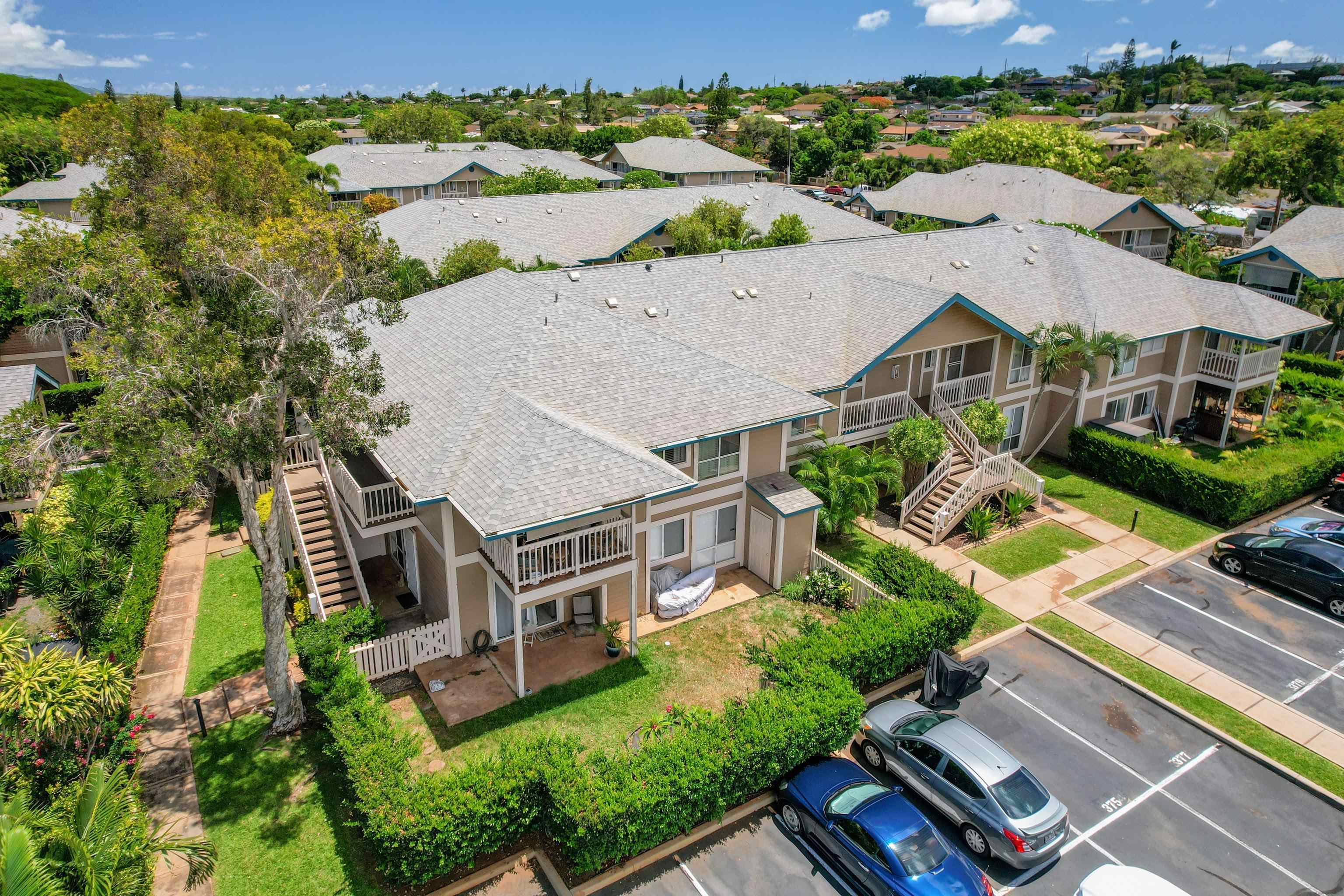 an aerial view of a house with garden space and ocean view