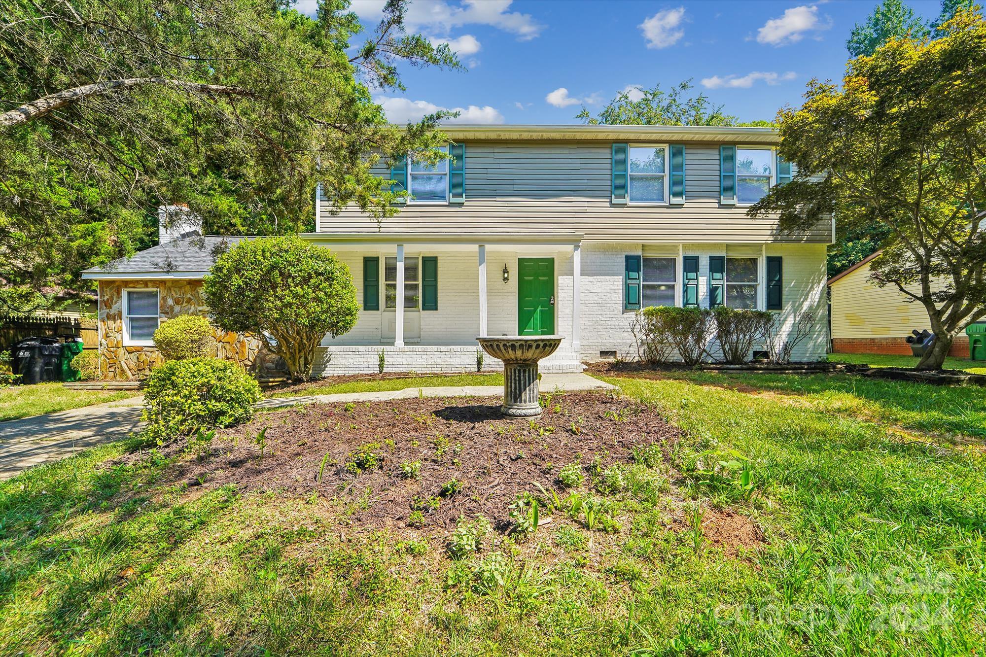 a front view of a house with garden