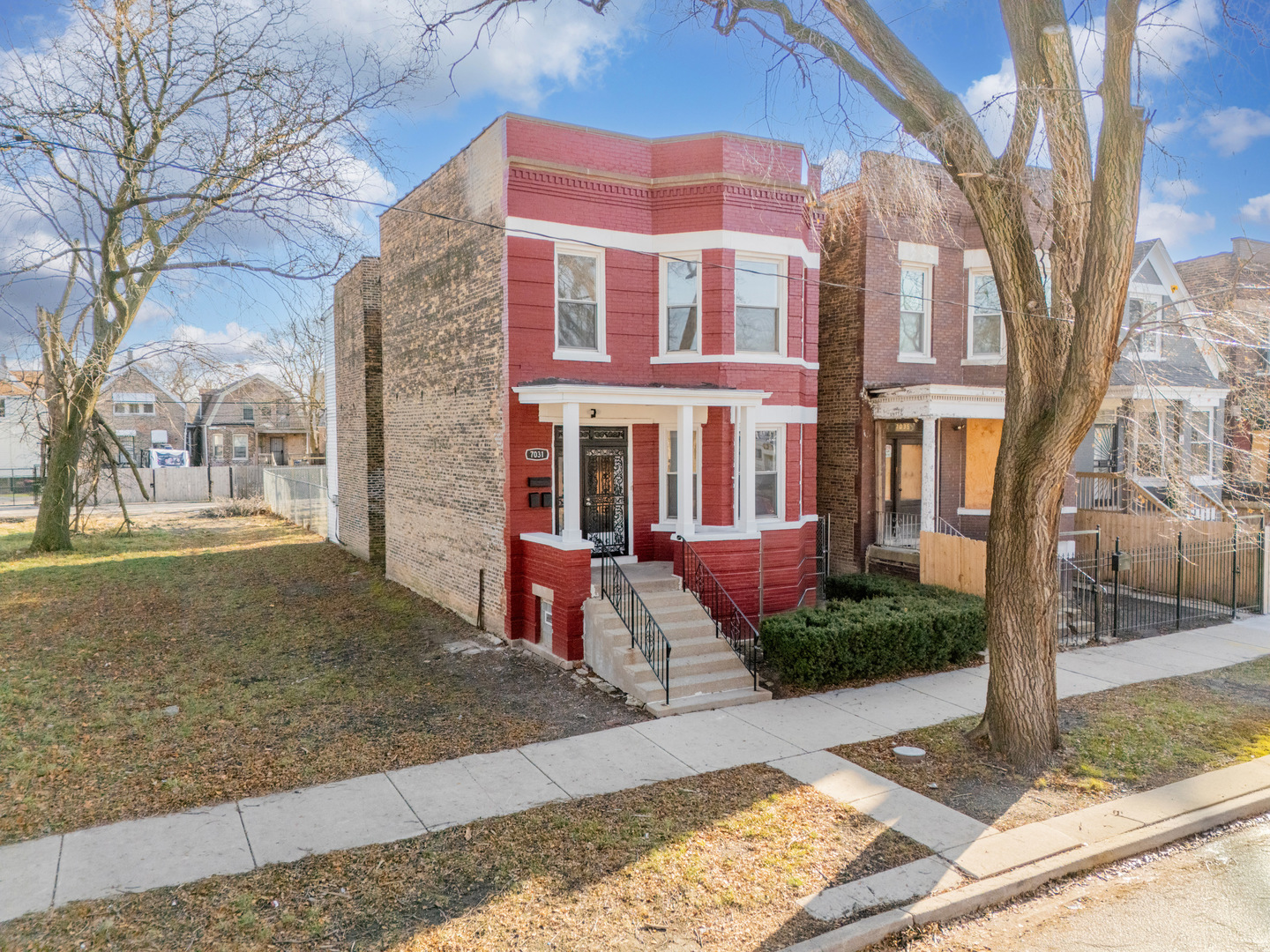 a view of a brick building next to a yard