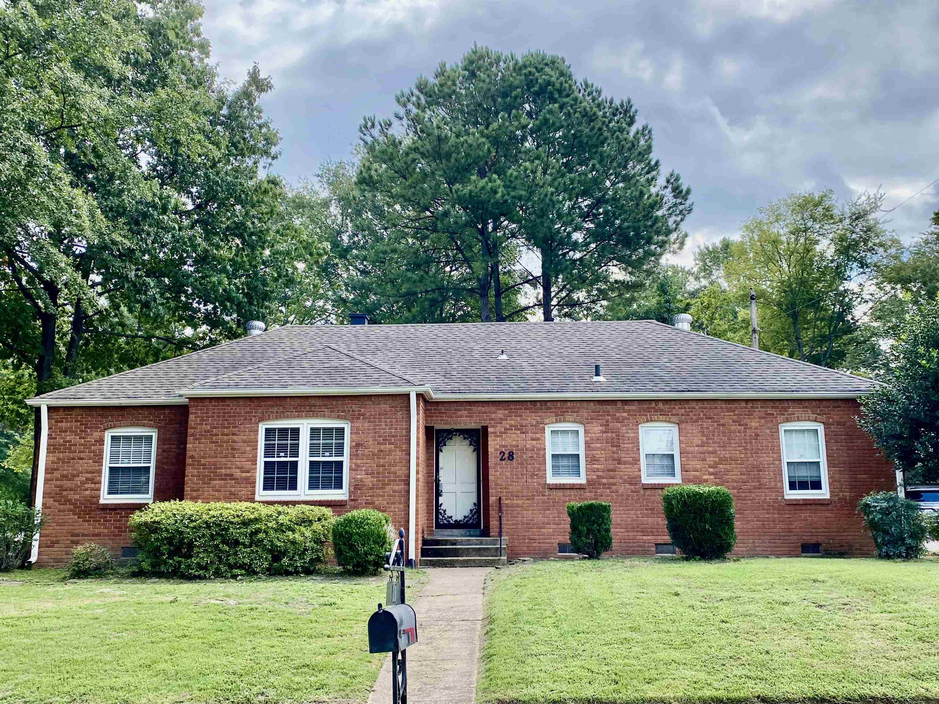 a front view of a house with garden and porch