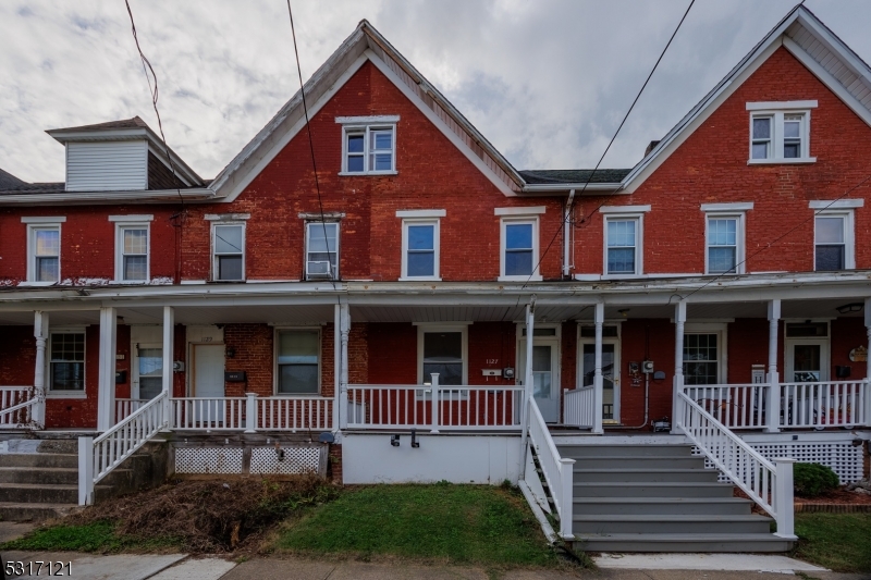 a front view of a house with windows and a yard