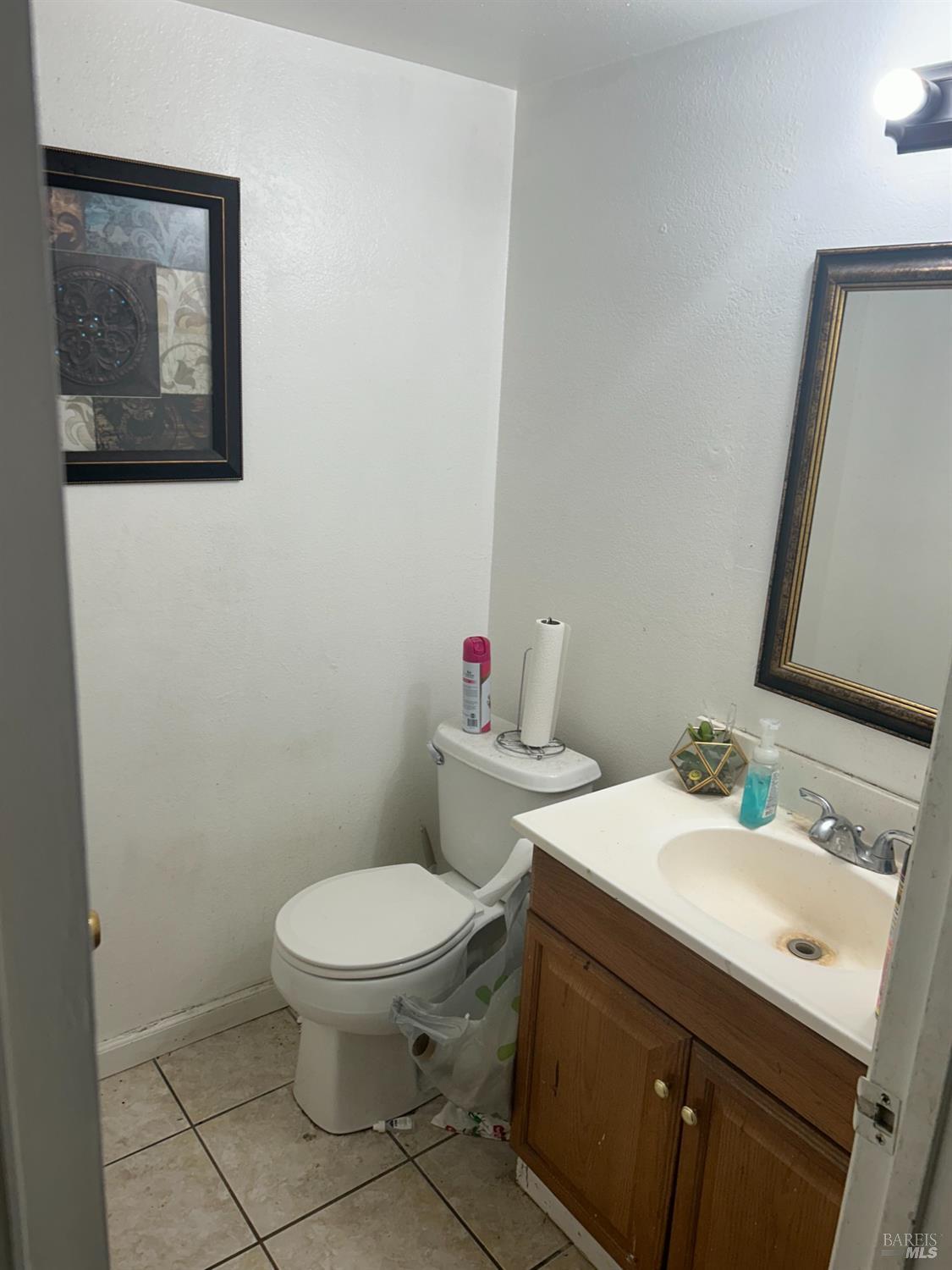 a white toilet sitting next to a bathroom sink