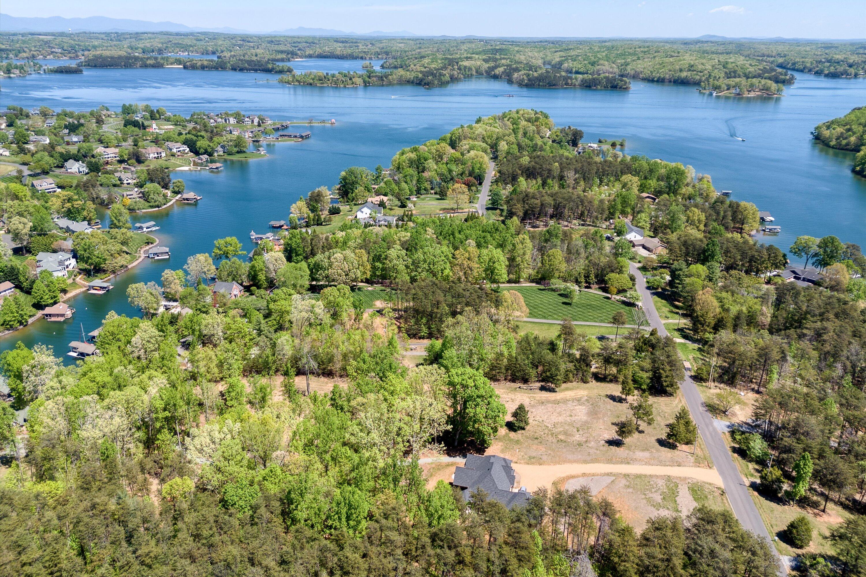 an aerial view of a houses with a lake view