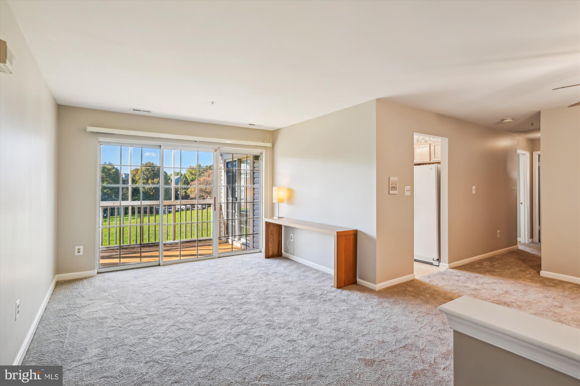 a view of a livingroom with a furniture and floor to ceiling window