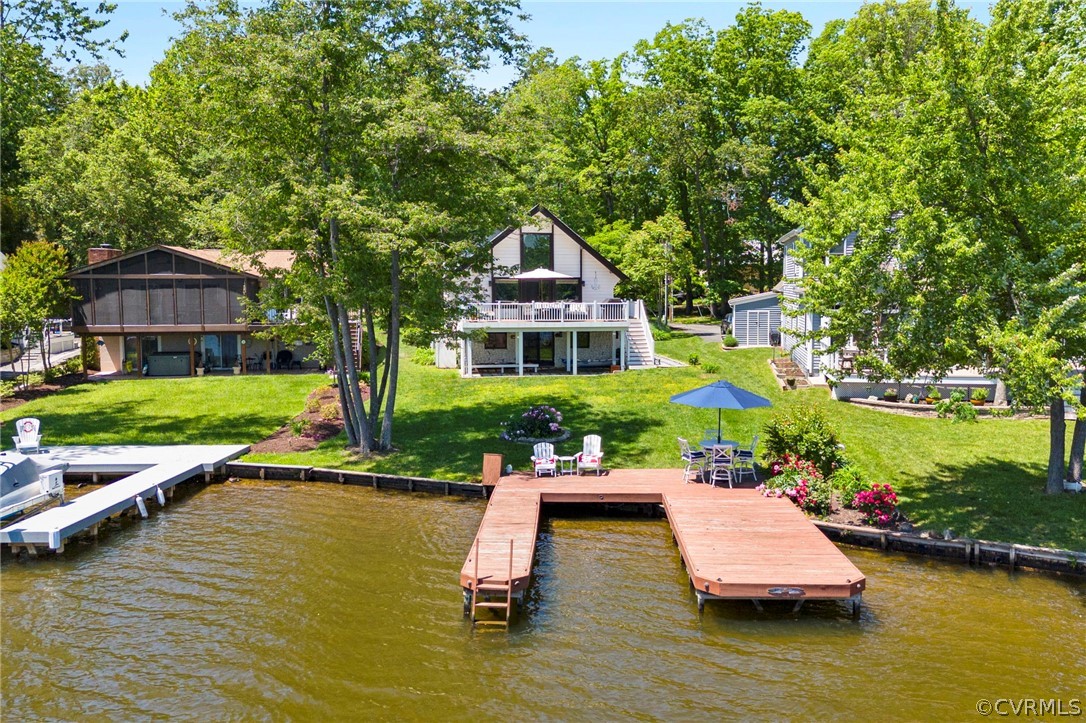 a view of a house with patio outdoor seating area and trees around