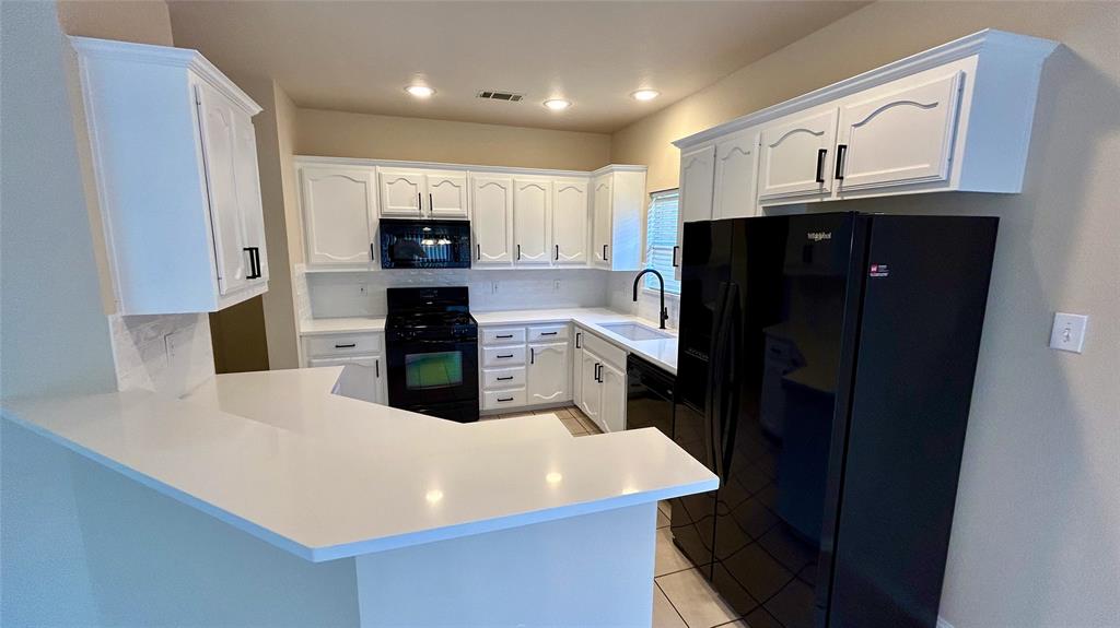 a kitchen with stainless steel appliances a refrigerator sink and microwave