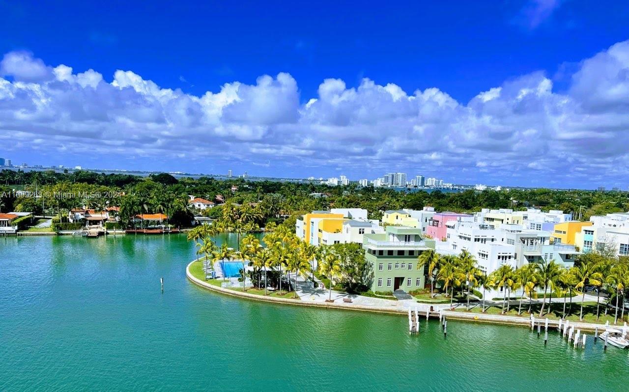 a view of a lake with houses in the back