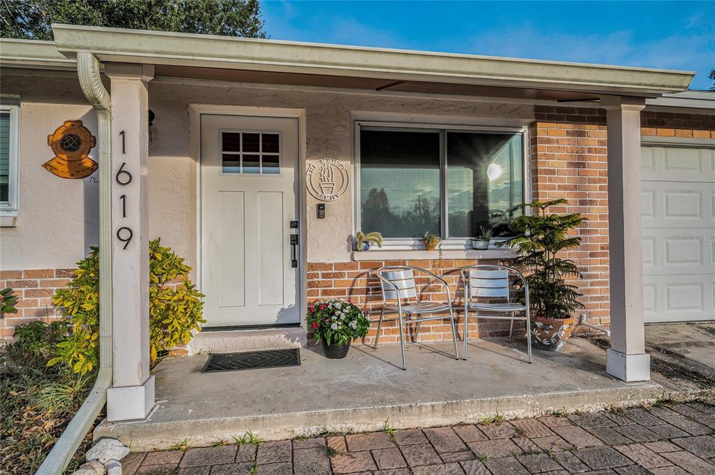 a front view of a house with outdoor seating