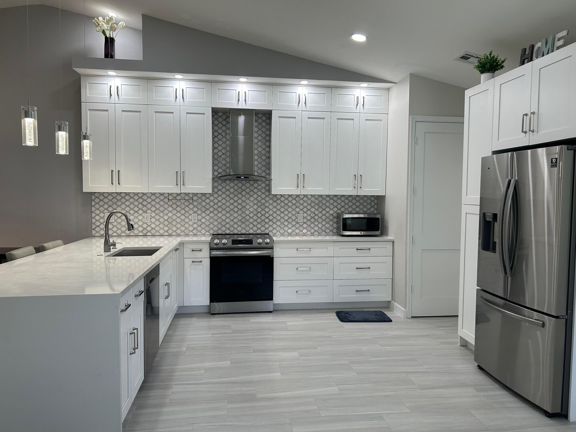 a kitchen with stainless steel appliances a refrigerator sink and stove