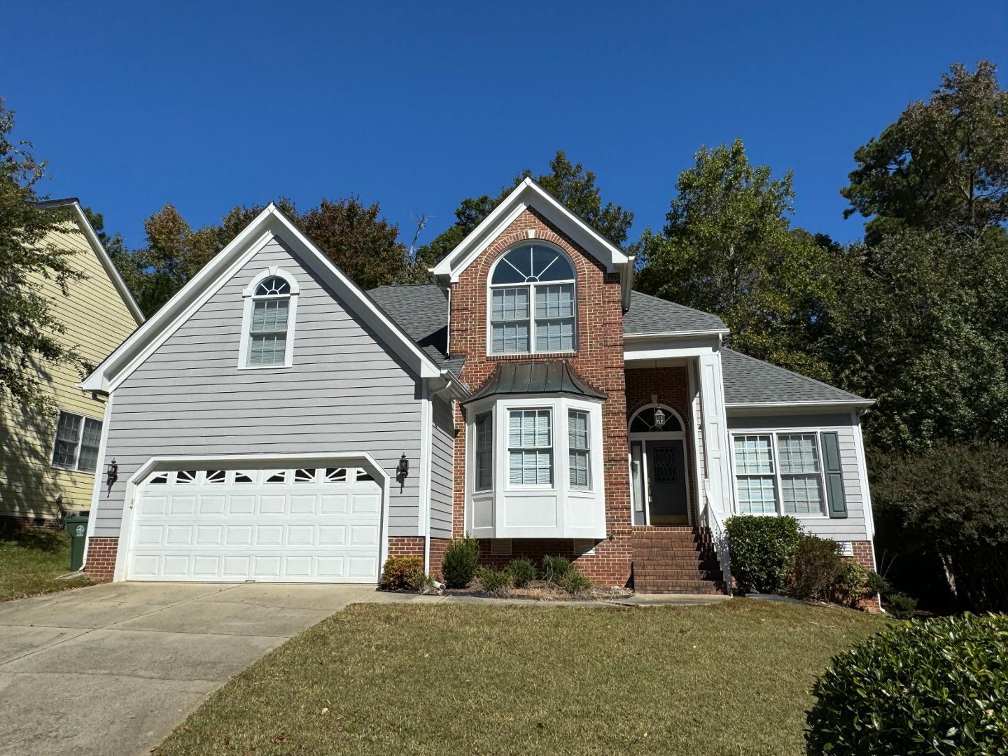 a front view of a house with a yard and garage