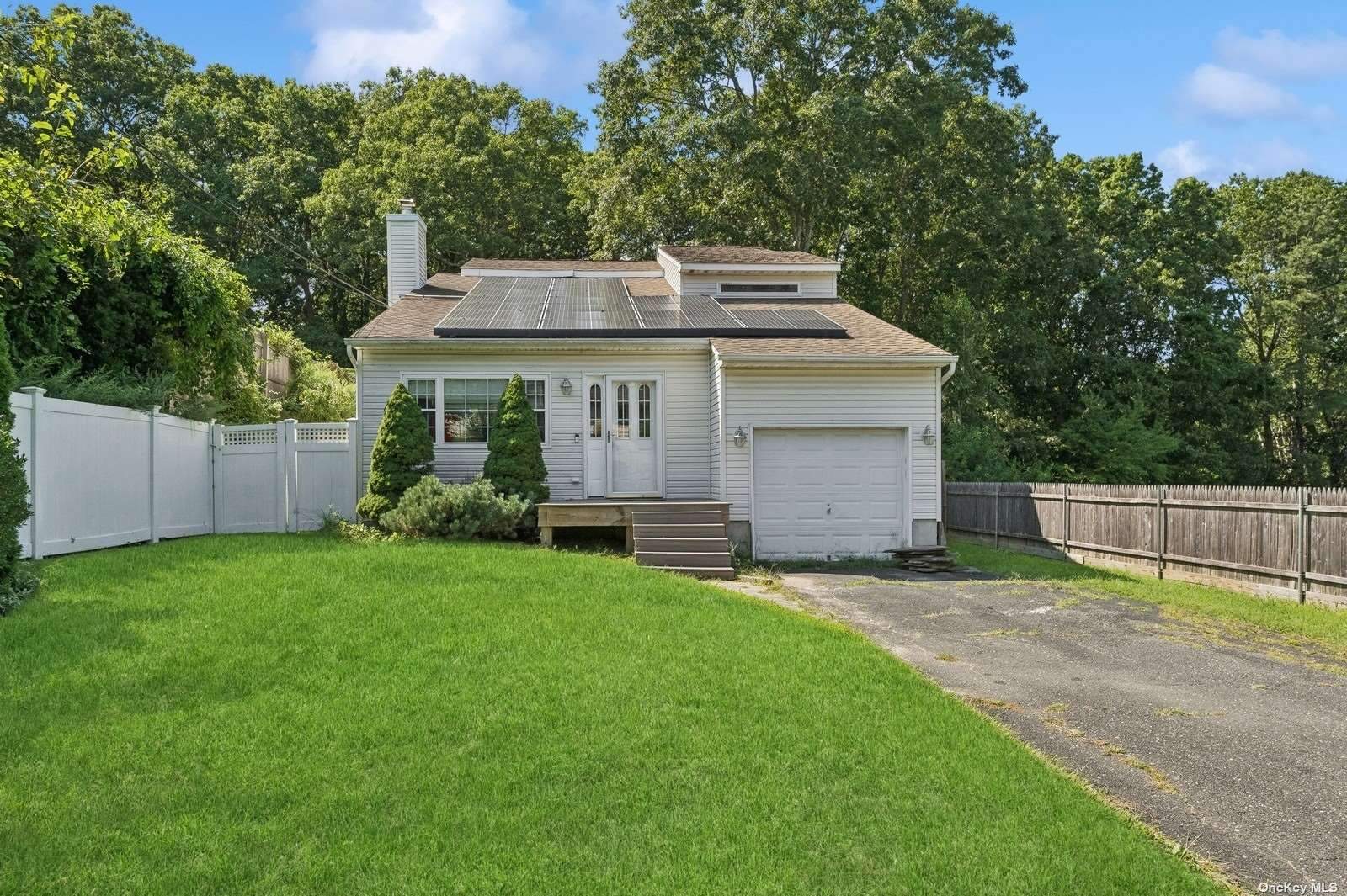 a aerial view of a house with a yard and fence