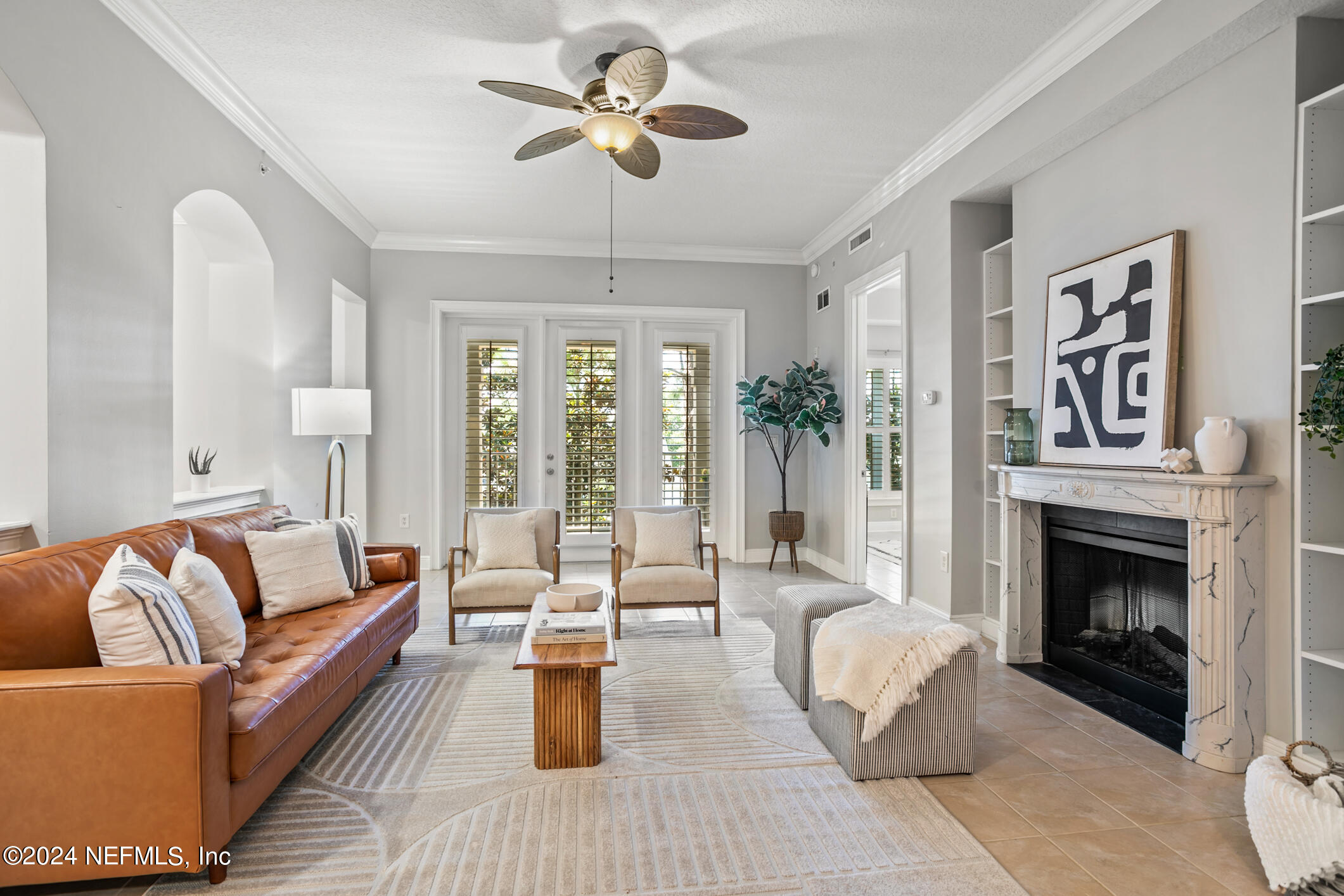 a living room with furniture fireplace and a chandelier