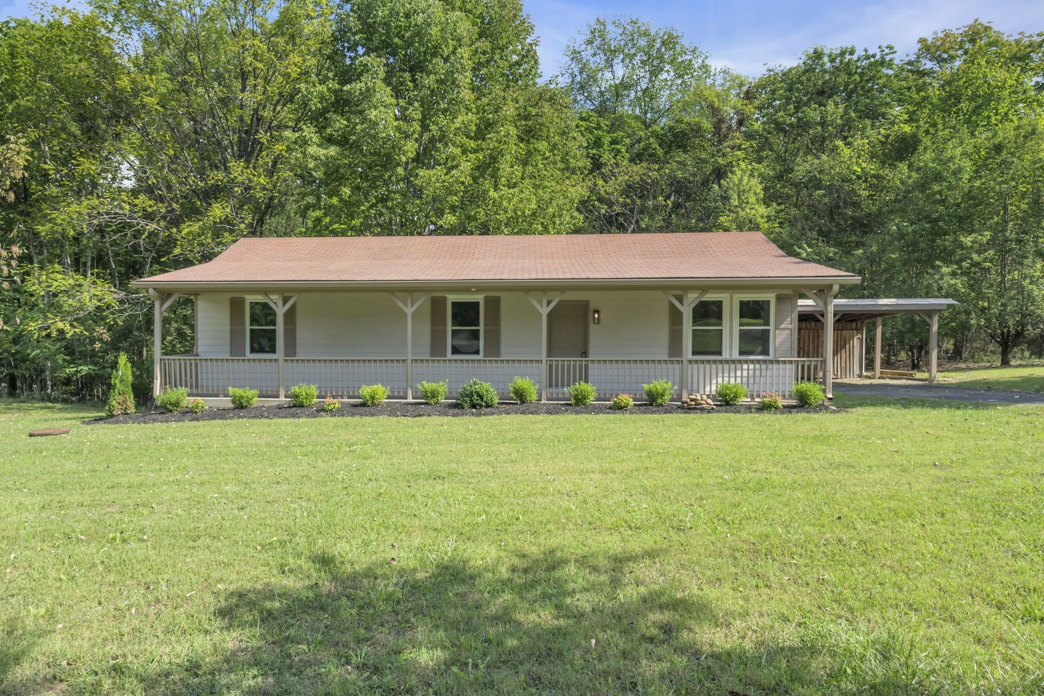 a front view of a house with a garden