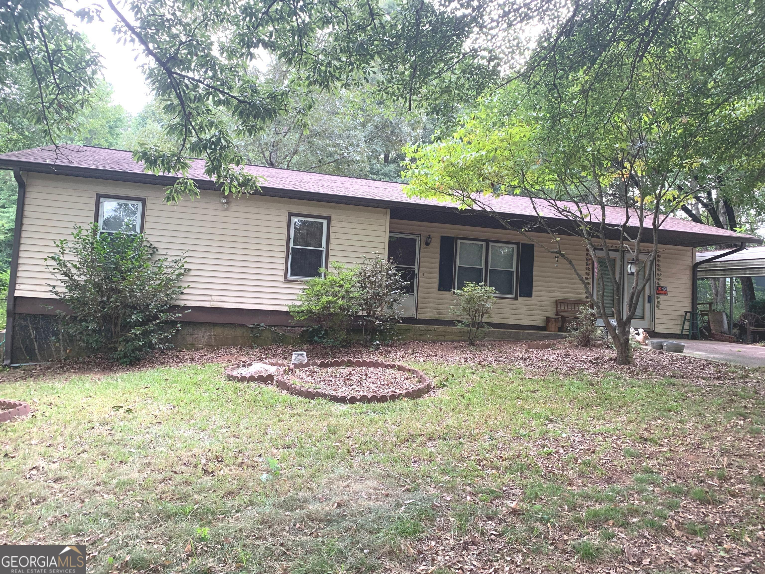 a front view of house with yard and outdoor seating