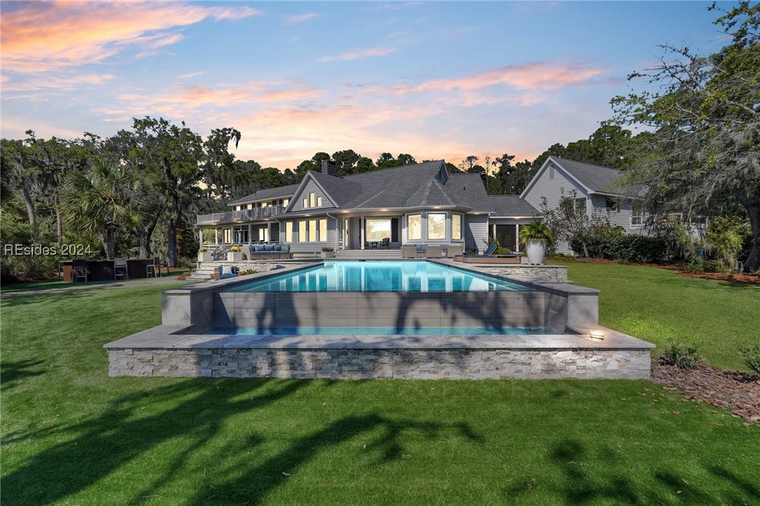 Pool at dusk with a lawn