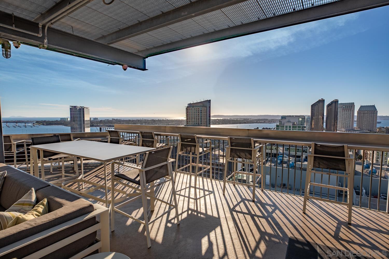 a roof deck with table and chairs