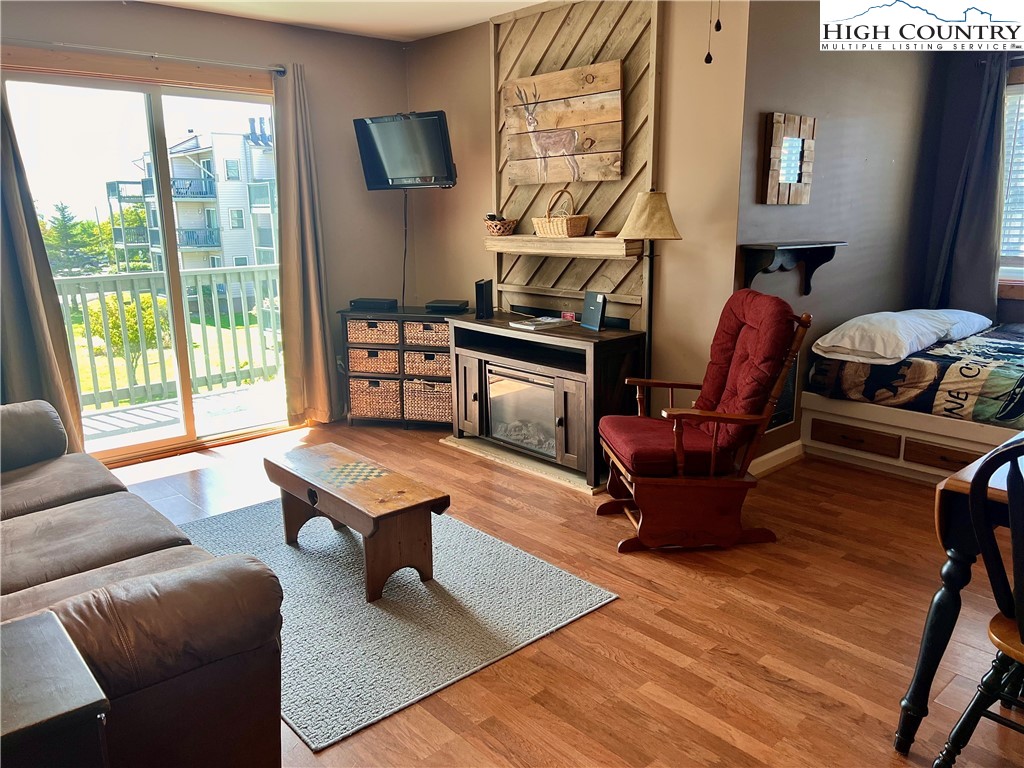 a living room with furniture rug and wooden floor