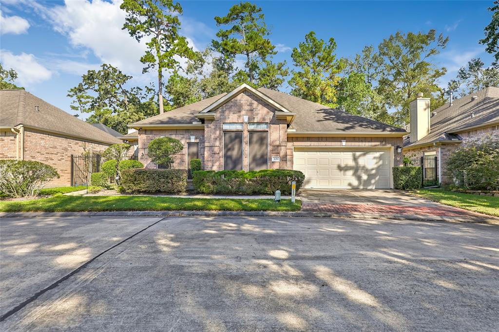 a view of a house with a yard and large trees