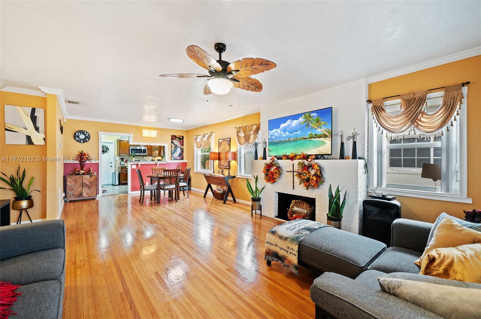 a living room with furniture a fireplace and a flat screen tv