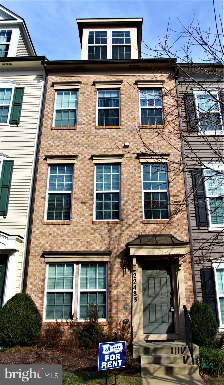 a front view of a building with parking space