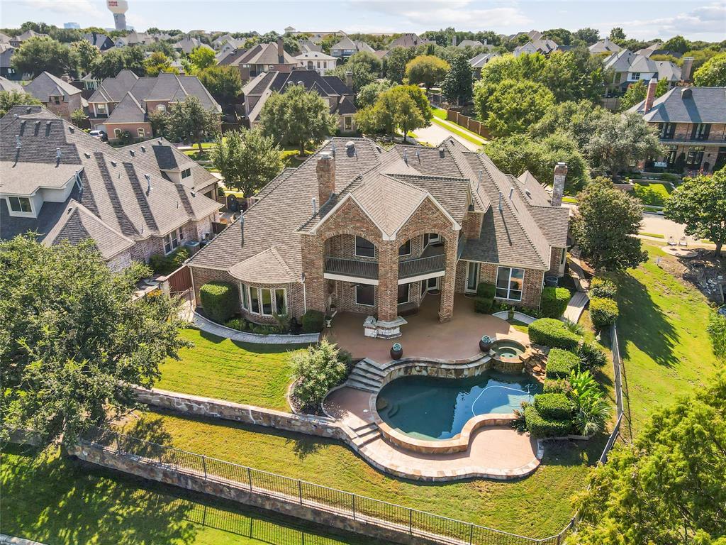 an aerial view of a house with swimming pool and lake view