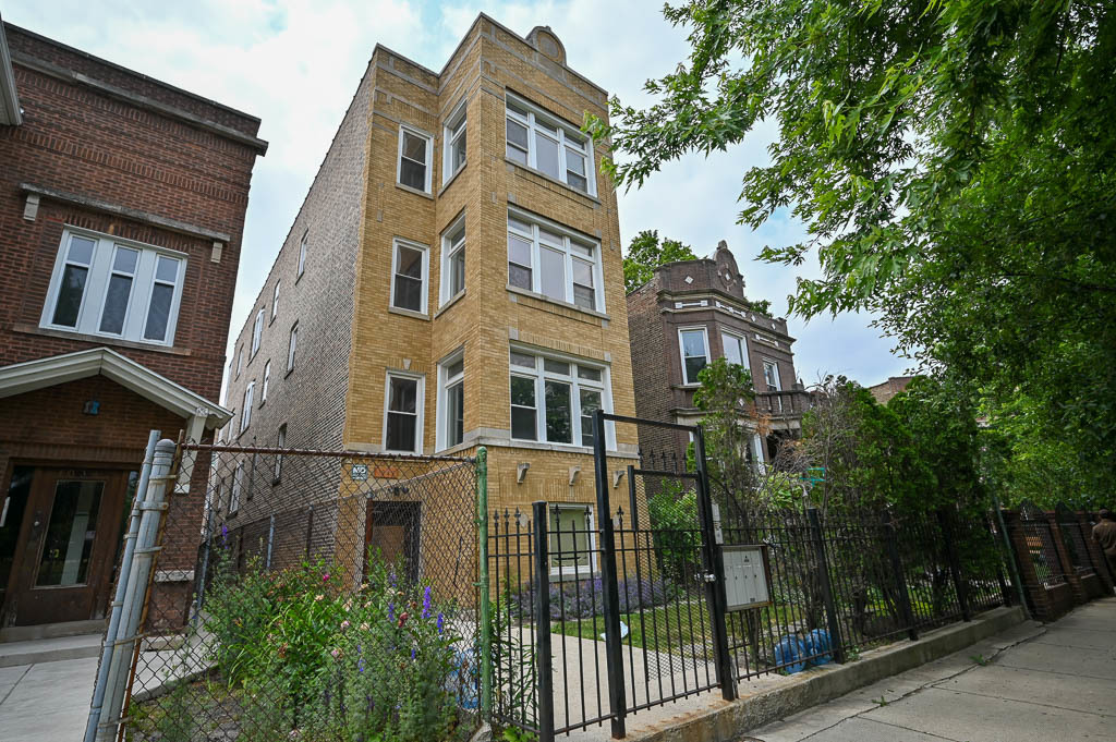 a view of a brick building next to a yard