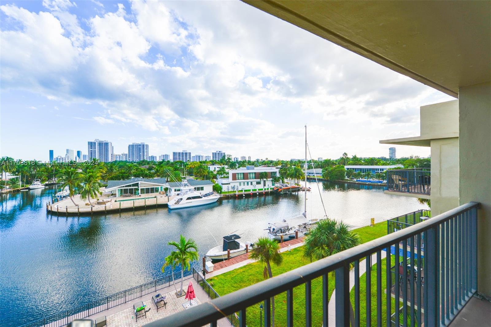 a view of a lake from a balcony with outdoor seating