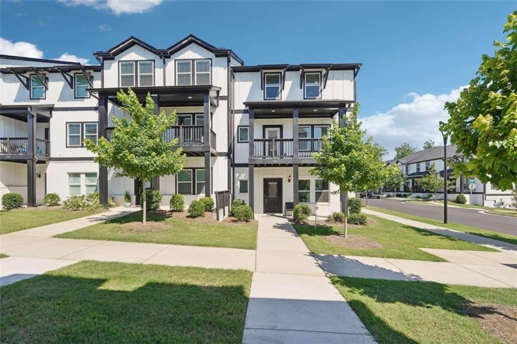 a front view of a residential apartment building with a yard