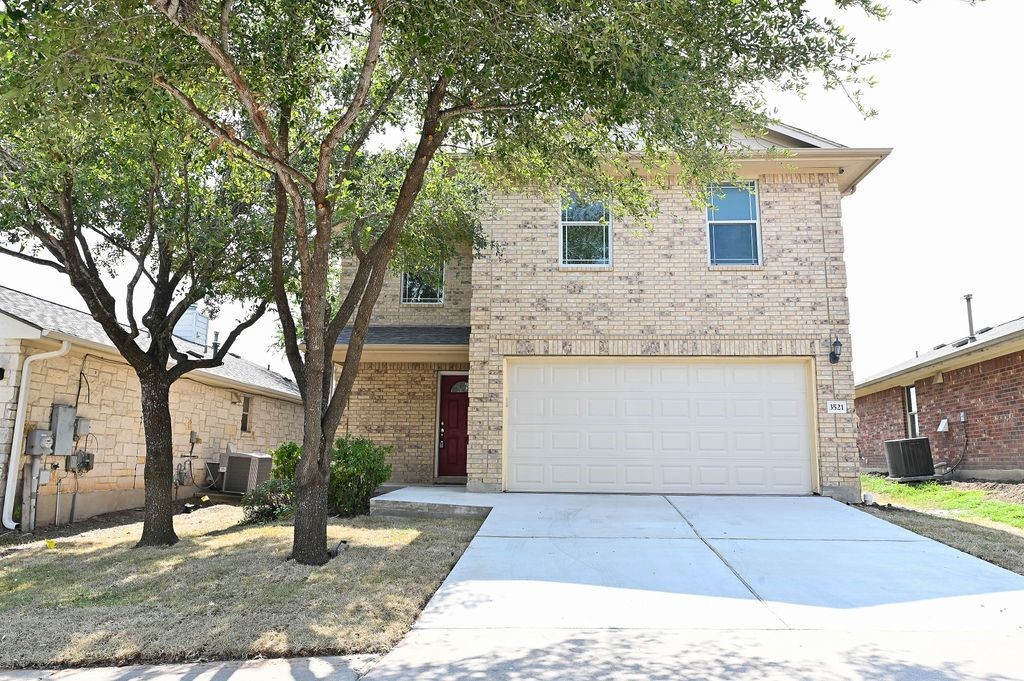 a front view of a house with a yard and garage